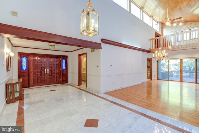 entrance foyer featuring light hardwood / wood-style floors, high vaulted ceiling, beam ceiling, and ceiling fan with notable chandelier