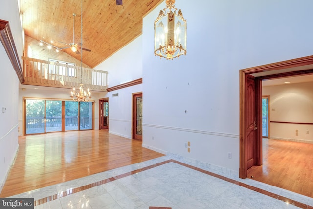 empty room with light hardwood / wood-style flooring, wood ceiling, high vaulted ceiling, and ceiling fan with notable chandelier