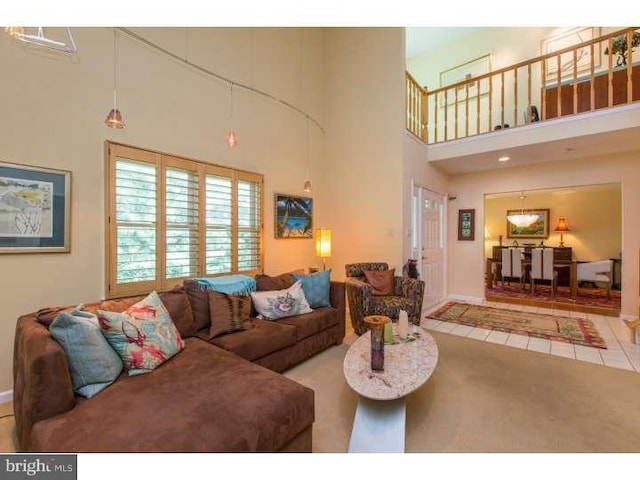 living room featuring a towering ceiling and light tile patterned flooring