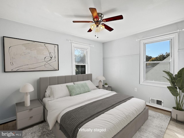 bedroom with hardwood / wood-style flooring and ceiling fan