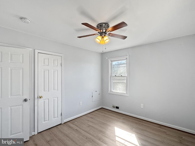 spare room featuring ceiling fan and light wood-type flooring