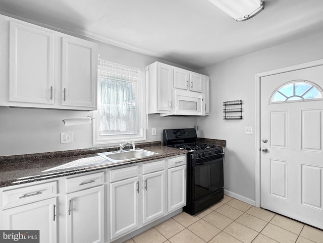 kitchen with sink, light tile patterned floors, white cabinetry, and black gas range oven