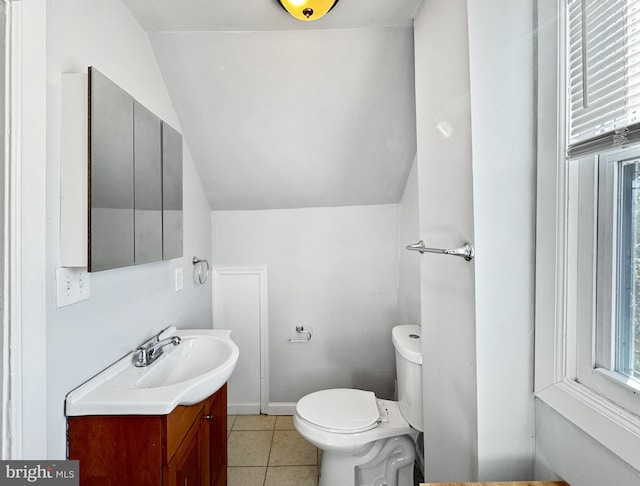 bathroom featuring vanity, toilet, lofted ceiling, and tile patterned flooring