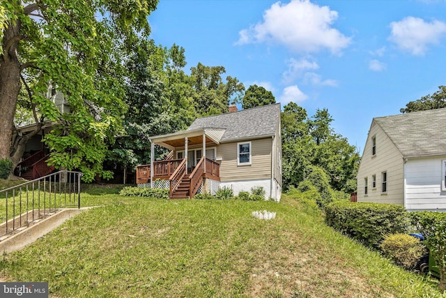 view of front of house with a front lawn and a deck