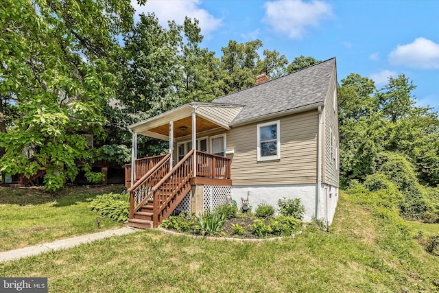 view of front of property with a front lawn and a deck