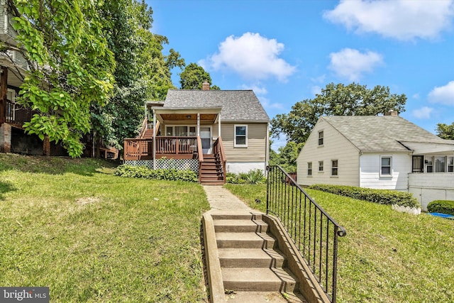 bungalow-style home featuring a wooden deck and a front lawn