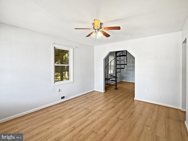 empty room with light wood-type flooring and ceiling fan