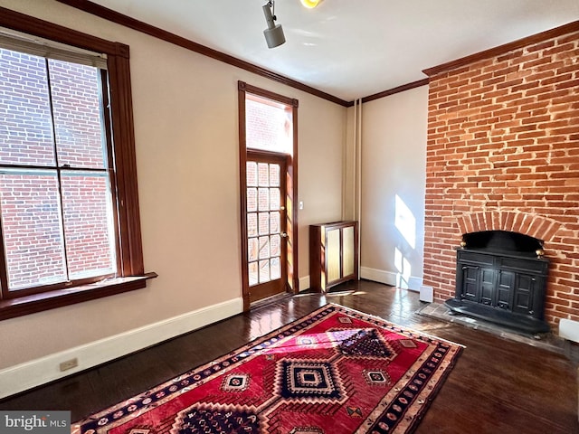 unfurnished living room featuring baseboards, ornamental molding, and dark wood-type flooring