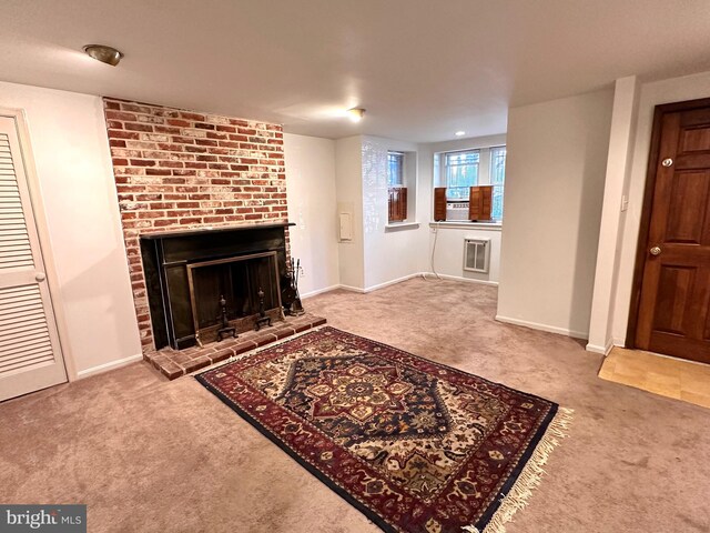 carpeted living room with heating unit and a brick fireplace