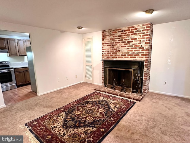 unfurnished living room with baseboards, light carpet, and a brick fireplace