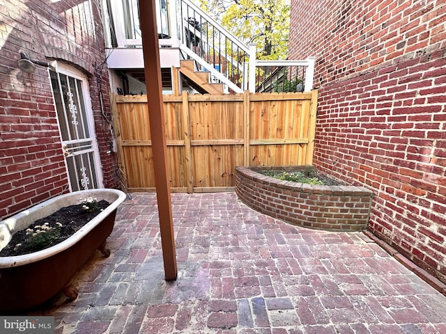 view of patio / terrace with stairs and fence