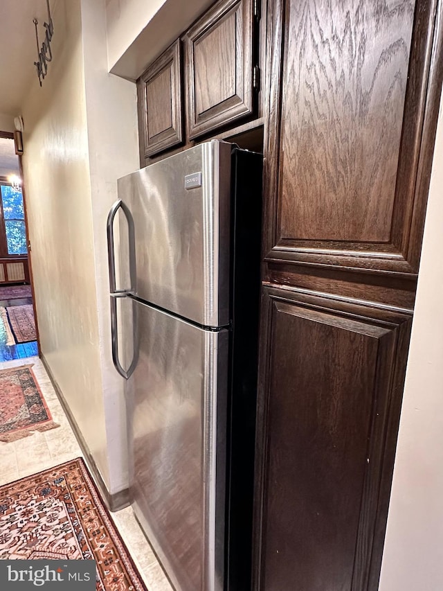 kitchen featuring dark brown cabinets and stainless steel refrigerator