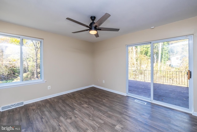 empty room featuring dark wood-type flooring and ceiling fan