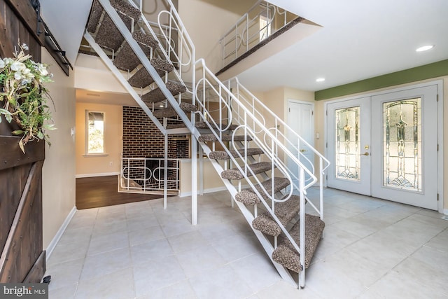 stairs featuring french doors and hardwood / wood-style flooring