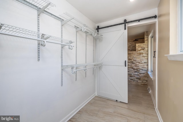 spacious closet with a barn door