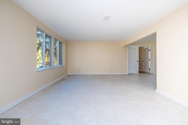 spare room featuring light tile patterned floors