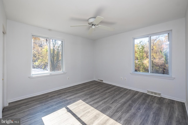 empty room featuring dark wood-type flooring and ceiling fan