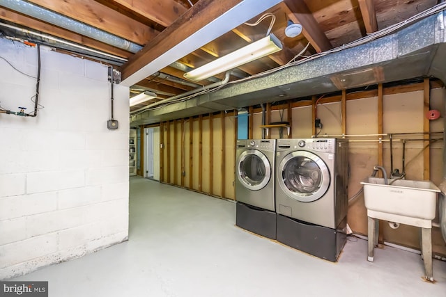 laundry room with independent washer and dryer and sink