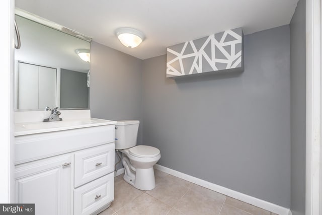 bathroom with vanity, toilet, and tile patterned flooring