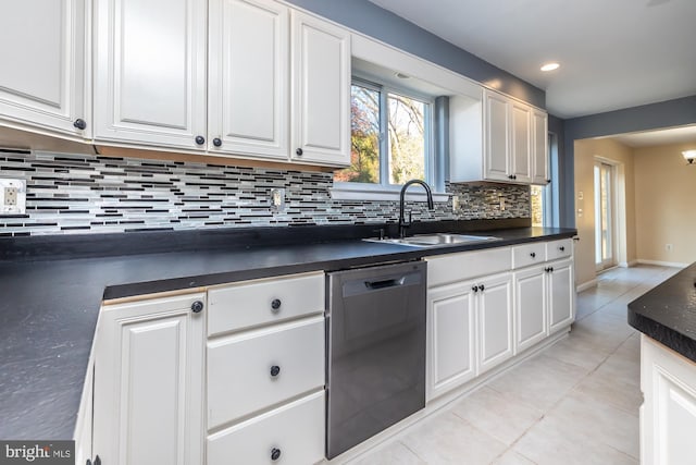 kitchen featuring tasteful backsplash, dishwasher, sink, white cabinetry, and light tile patterned floors