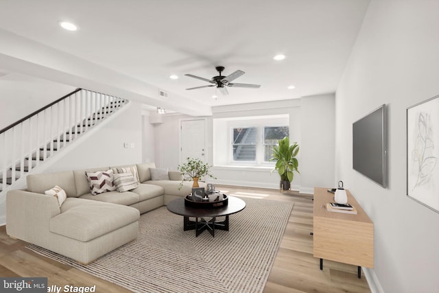 living room featuring ceiling fan and light wood-type flooring