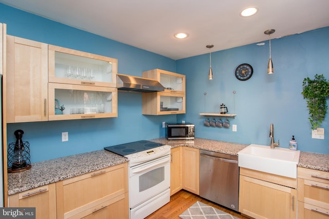 57 N Franklin St, Lambertville, NJ 08530 - kitchen featuring light brown cabinets, glass insert cabinets, a sink, wall chimney range hood, and stainless steel appliances