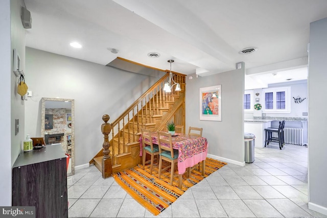 tiled dining room featuring a fireplace