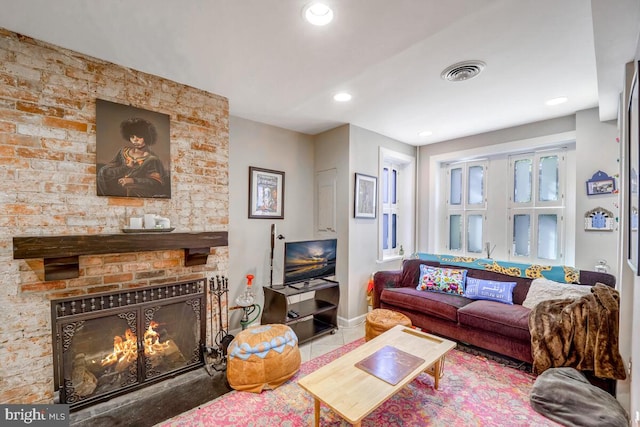 living room featuring tile patterned flooring and a large fireplace