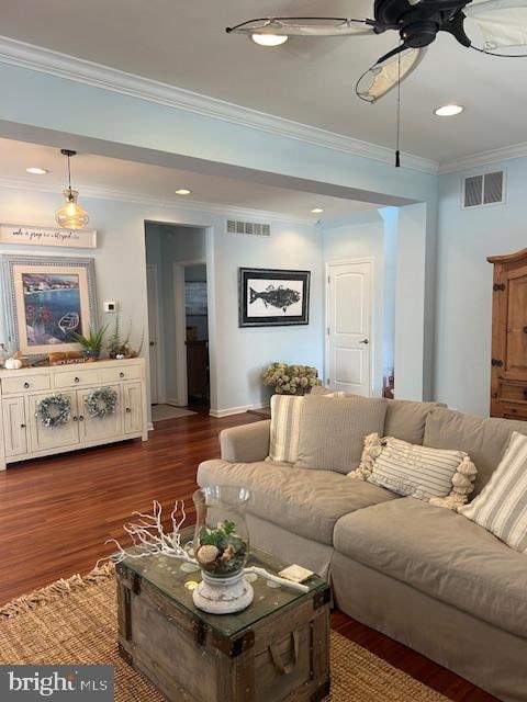 living room with ceiling fan, ornamental molding, and dark hardwood / wood-style floors