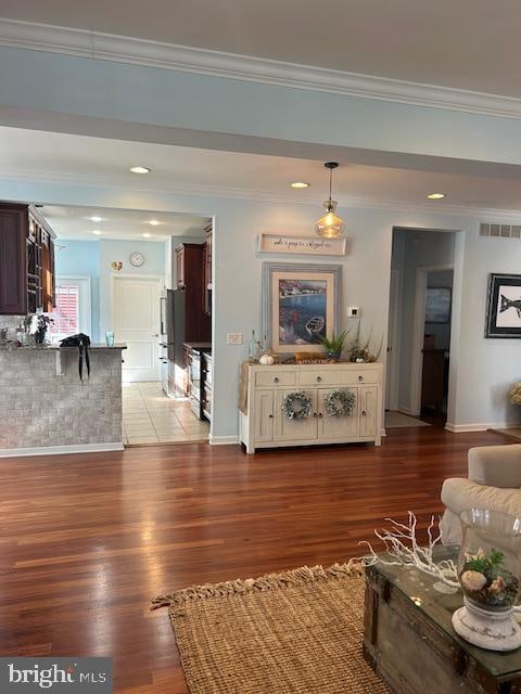 living room with crown molding and dark hardwood / wood-style floors