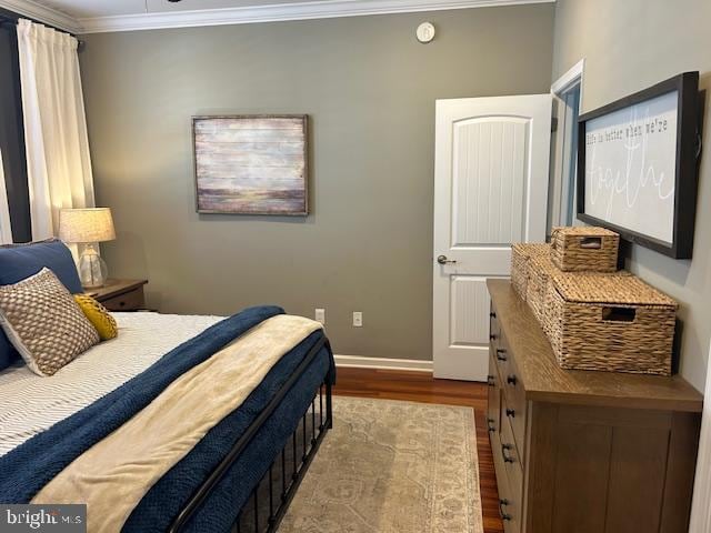 bedroom featuring crown molding and hardwood / wood-style flooring