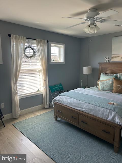 bedroom featuring light hardwood / wood-style flooring and ceiling fan