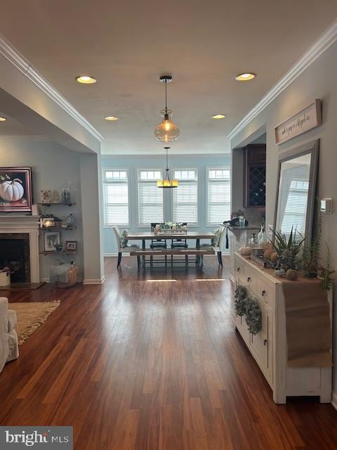 dining space with ornamental molding, a healthy amount of sunlight, and dark hardwood / wood-style flooring