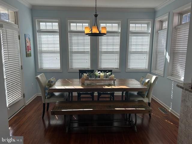 dining area with crown molding, plenty of natural light, and dark hardwood / wood-style floors