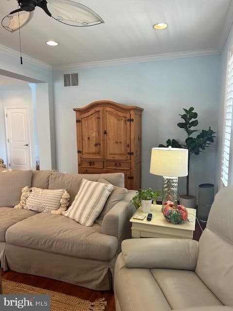 living room with crown molding and wood-type flooring