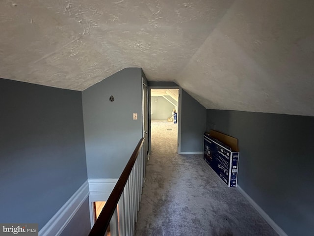 bonus room with a textured ceiling, carpet, and vaulted ceiling