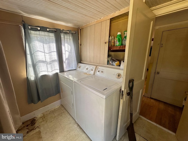 laundry room featuring wood ceiling and washing machine and clothes dryer