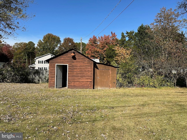 view of outbuilding with a lawn