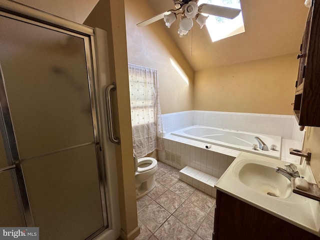 full bathroom featuring a skylight, independent shower and bath, toilet, tile patterned floors, and vanity