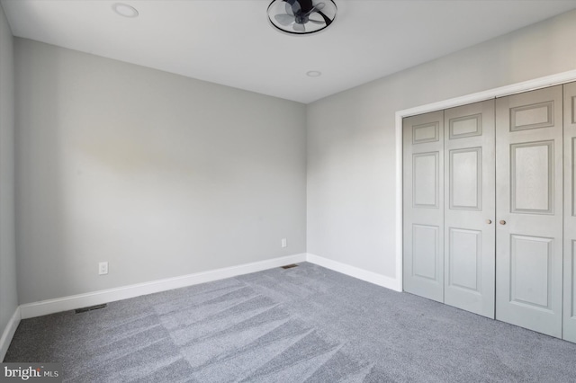 unfurnished bedroom with a closet and carpet