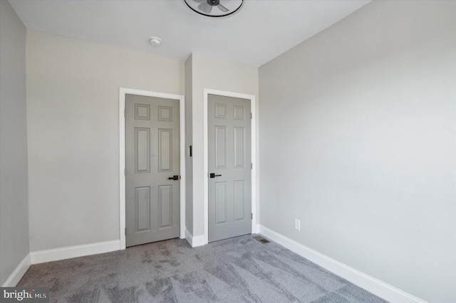 unfurnished bedroom featuring light carpet