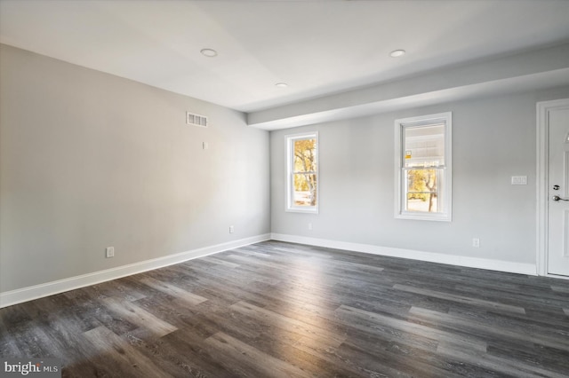 empty room with dark wood-type flooring