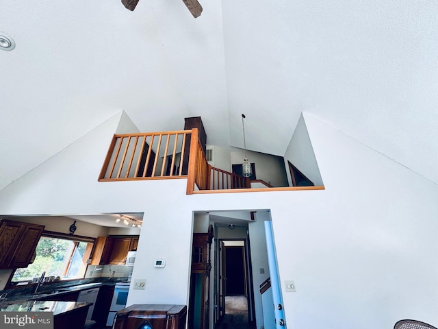 interior space featuring white appliances, ceiling fan, and sink