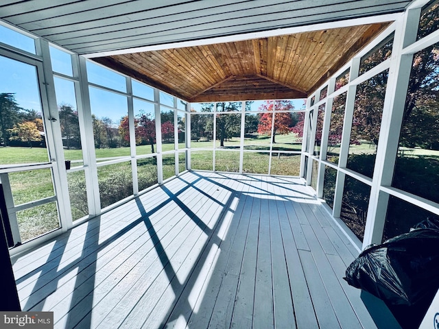 sunroom featuring lofted ceiling and wood ceiling