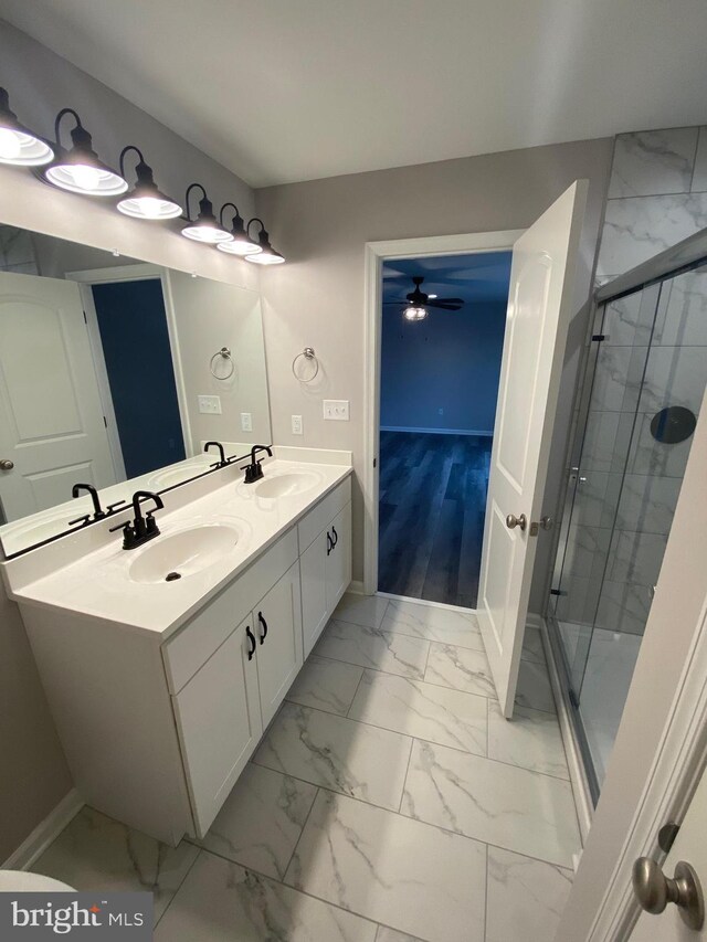 bathroom with vanity, ceiling fan, and walk in shower