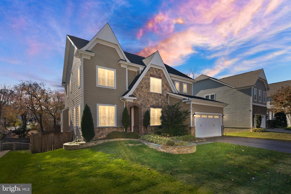 view of front of home with a garage and a yard