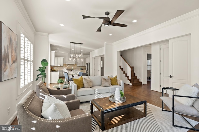 living room with ceiling fan, dark hardwood / wood-style flooring, and ornamental molding