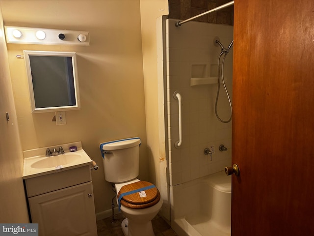 bathroom featuring toilet, vanity, and tile patterned flooring