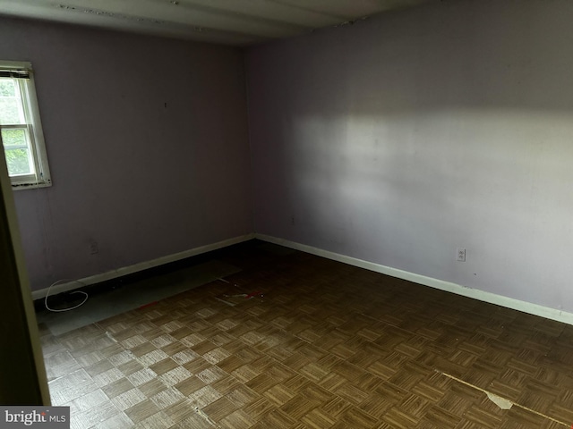 spare room featuring parquet flooring