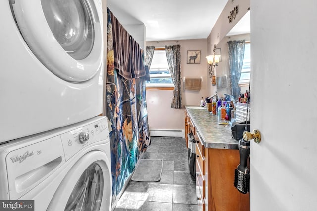 washroom with stacked washer and clothes dryer and a baseboard radiator